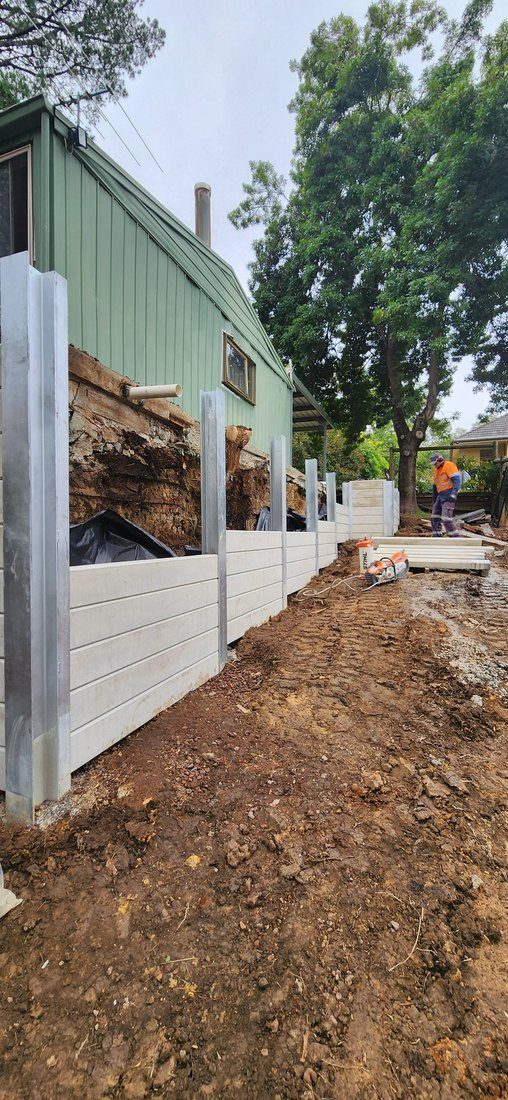 Concrete sleepers and drainage going in behind the new wall