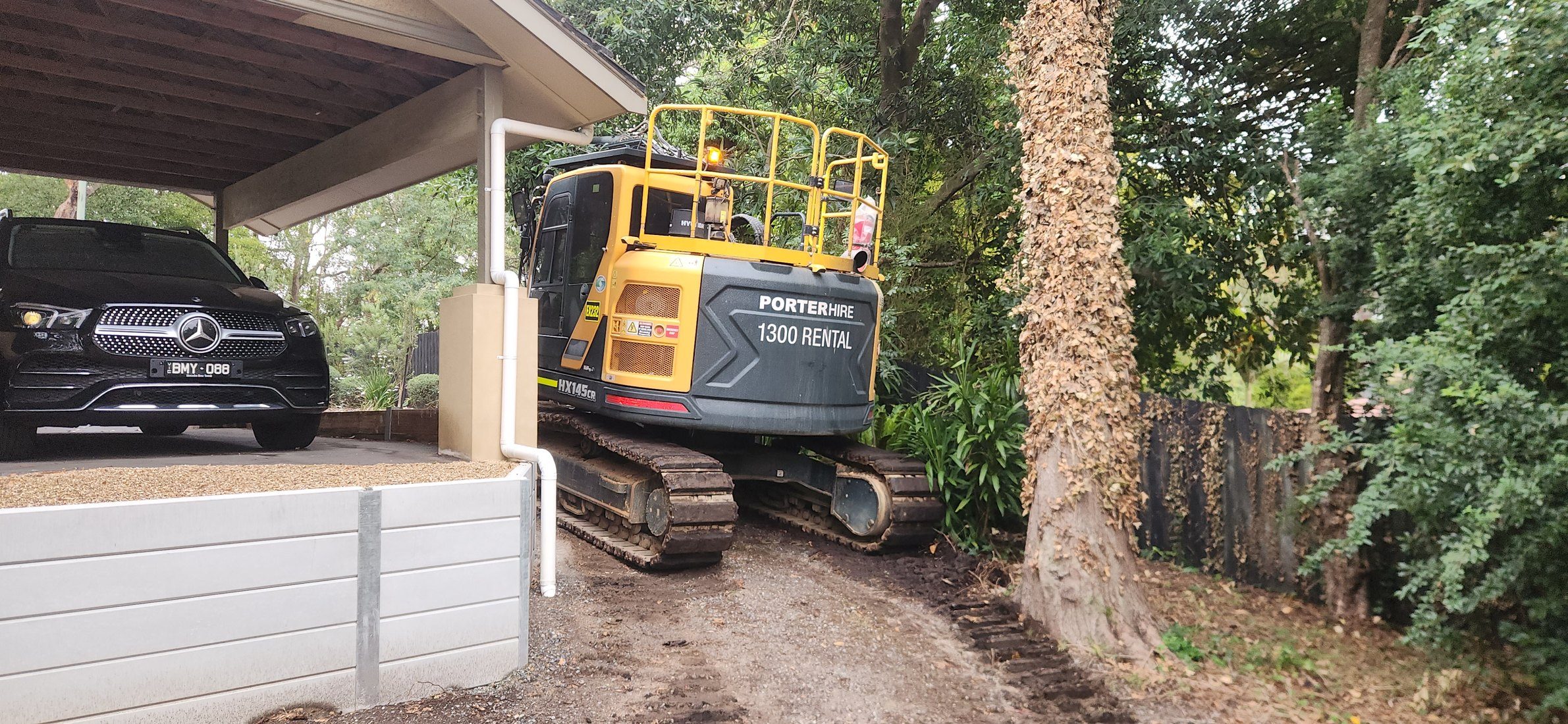 Machinery working in the restricted space beside the building