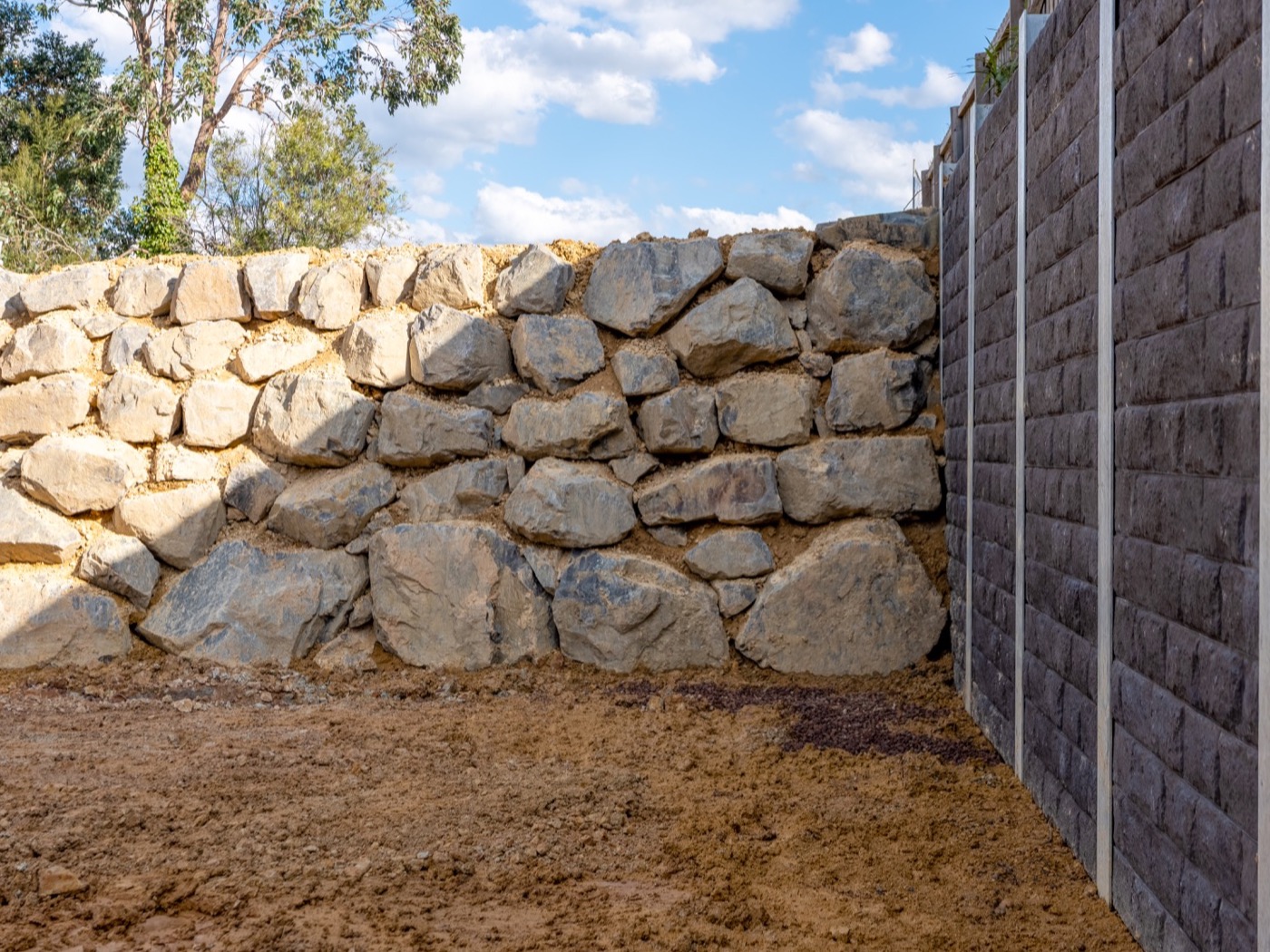 Finished quarry rock wall at full height, engineered sleeper wall behind