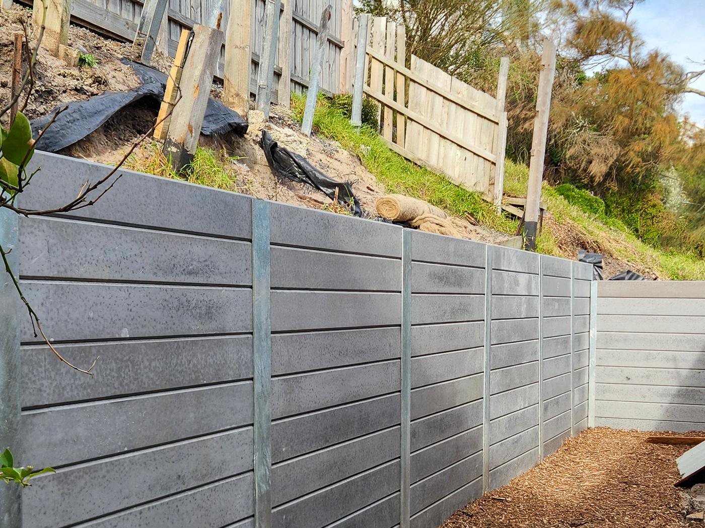 Concrete sleeper wall stepping down a slope