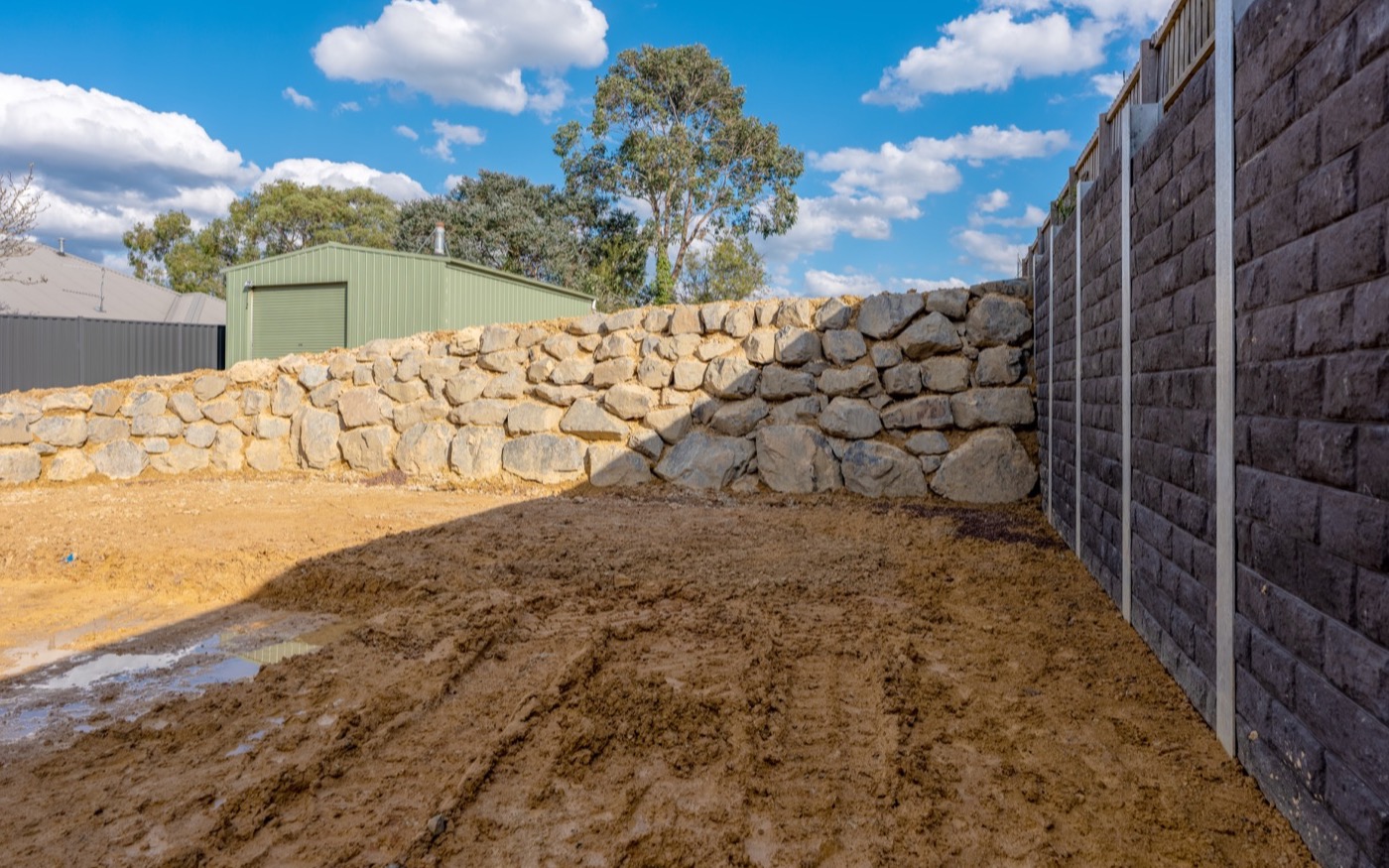 The transition from the engineered wall to the quarry rock walls